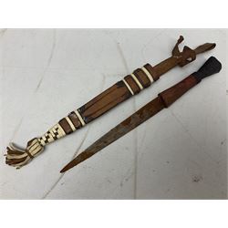 Indian kukri with 29cm curving steel blade and nickel mounted horn grip; in leather covered scabbard with one skinning knife L42cm overall; Hitler Youth knife with scabbard in relic condition; and three African graduated knives each with crudely carved wooden grips and painted leather covered scabbards (5)