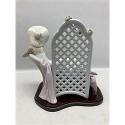 Lladro figure, Garden of Dreams, modelled as a woman reclining in front of trellis of flowers on a mahogany base, limited edition 3129/4000, sculpted by  José Puche, with original box, no 7634, year issued 1994, year retired 1996, H32cm
