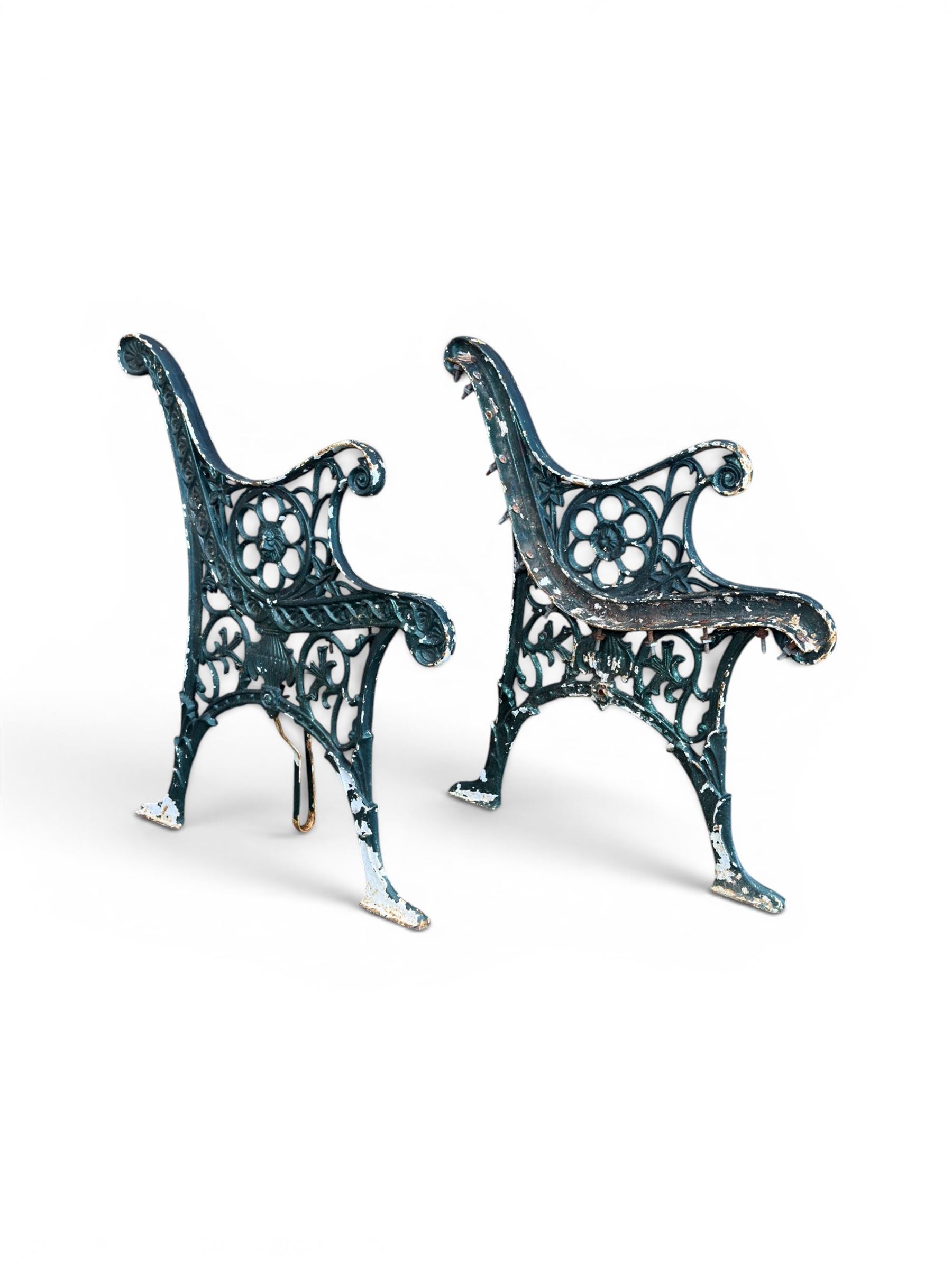 Pair of ornate painted cast iron bench ends, painted in green
