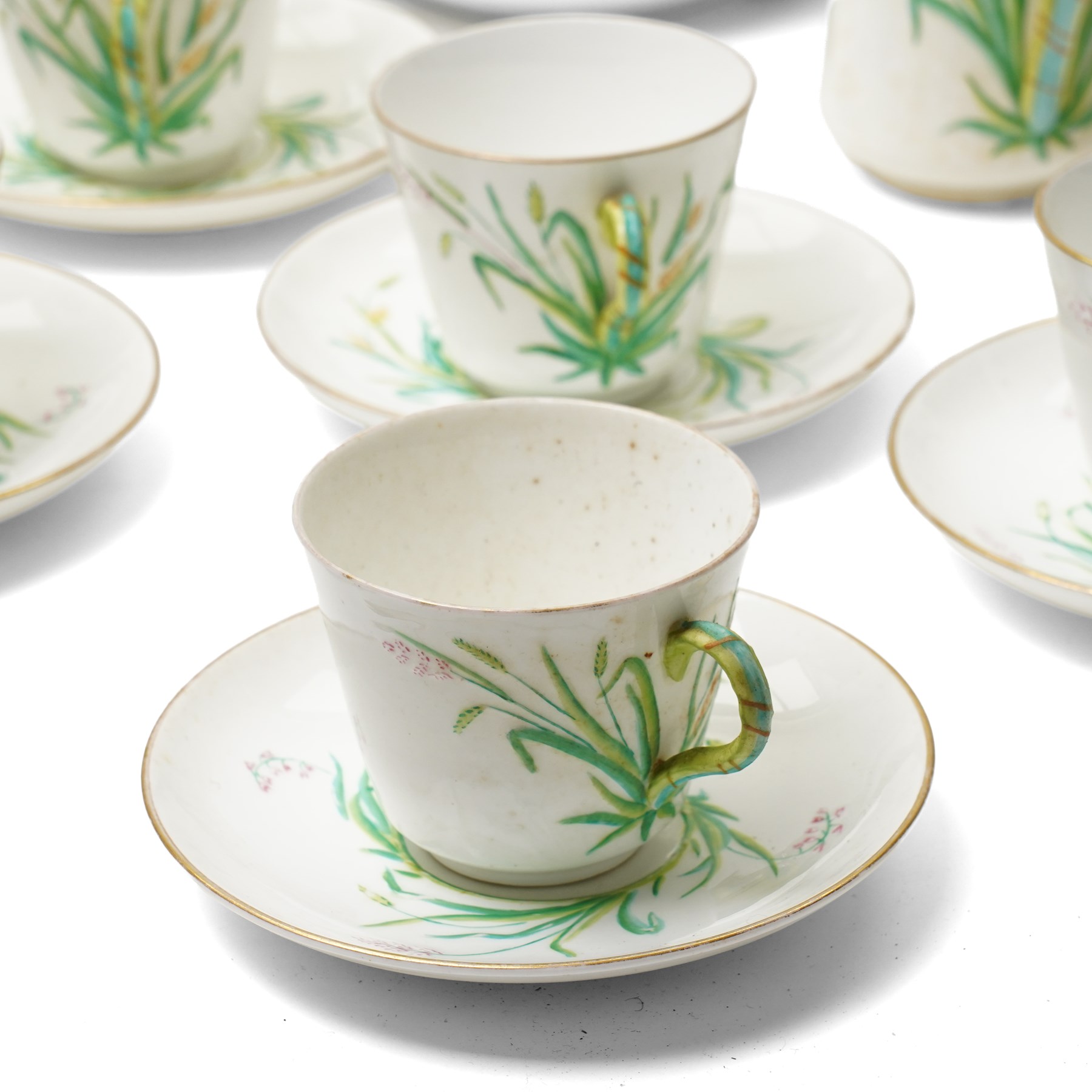 Victorian Copeland part tea service, painted in a Spring pattern with hay and flowers, comprising nine teacups and eleven saucers, teapot, milk jug, two large serving plates and three smaller and twelve side plates