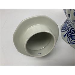 De Porceleyne Fles Delftware blue and white covered jar, of fluted baluster form, with floral and insect decoration, upon an octagonal foot, the octagonal cover with urn shaped finial, H32cm