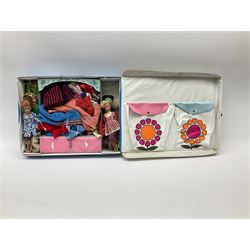 The World of Barbie Double Doll Case containing a quantity of assorted doll's clothing; together with two large and one small fashion dolls.