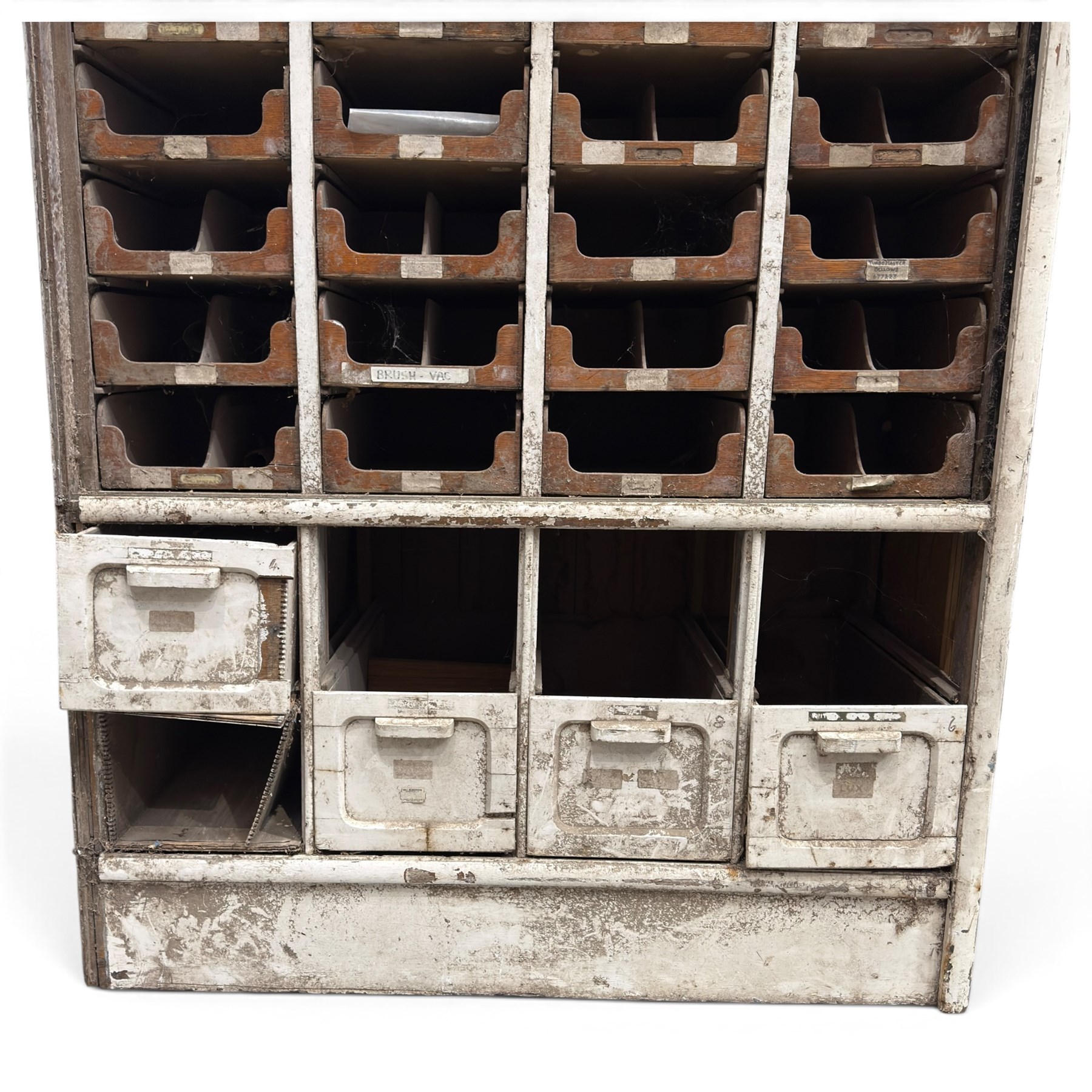 F Pollard & Co - late 19th century rustic haberdashery shop cabinet, fitted with an assortment of forty sliding trays, with drawers fitted to base, in antique white-painted finish