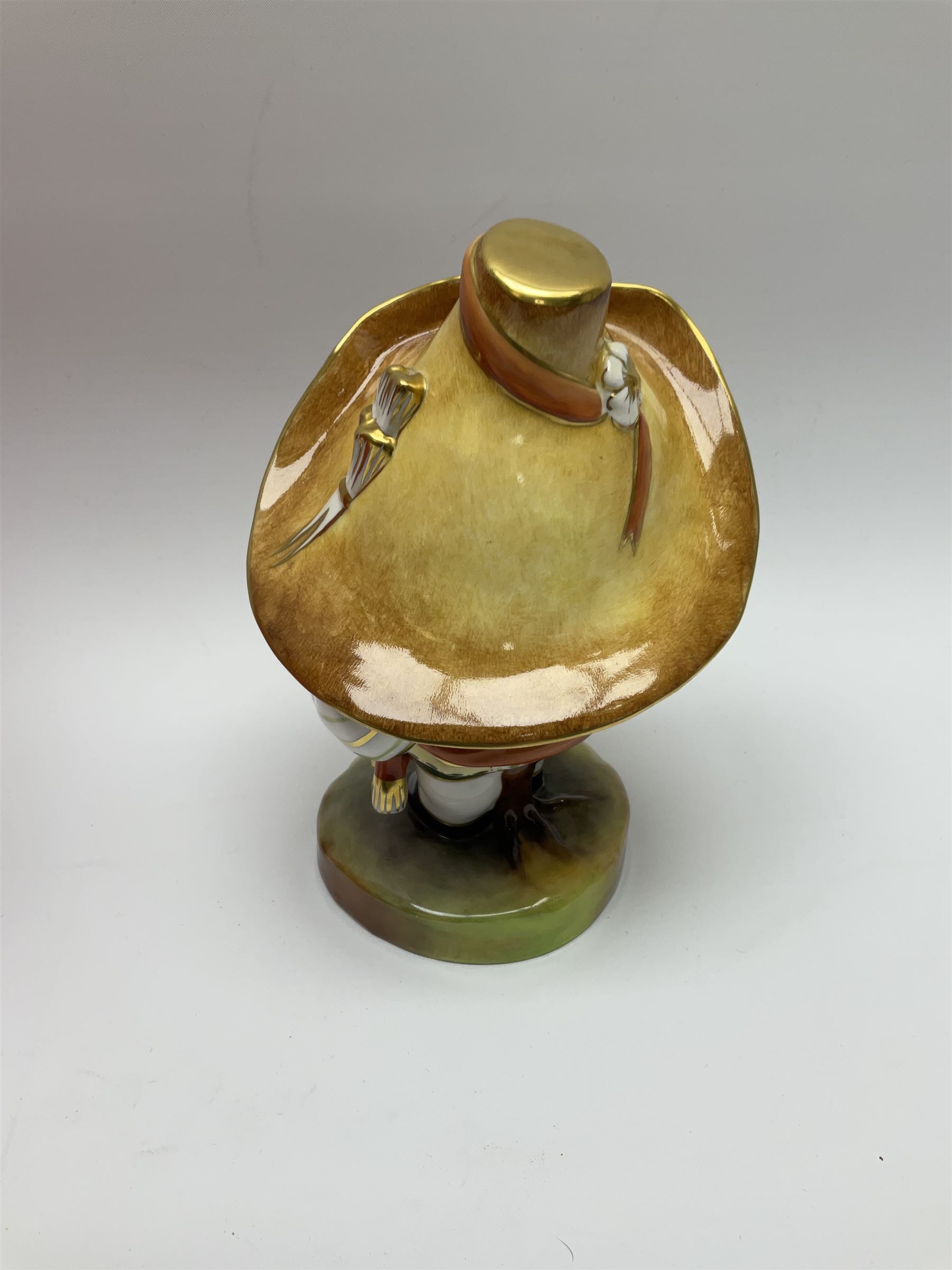 A Royal Crown Derby Mansion House dwarf, dressed in 17th century cavalier costume, with floral waistcoat and hate detailed Auction of Elegant Household Furniture and Effects, H18cm, with printed mark beneath and signed J.Aston, with makers box. 