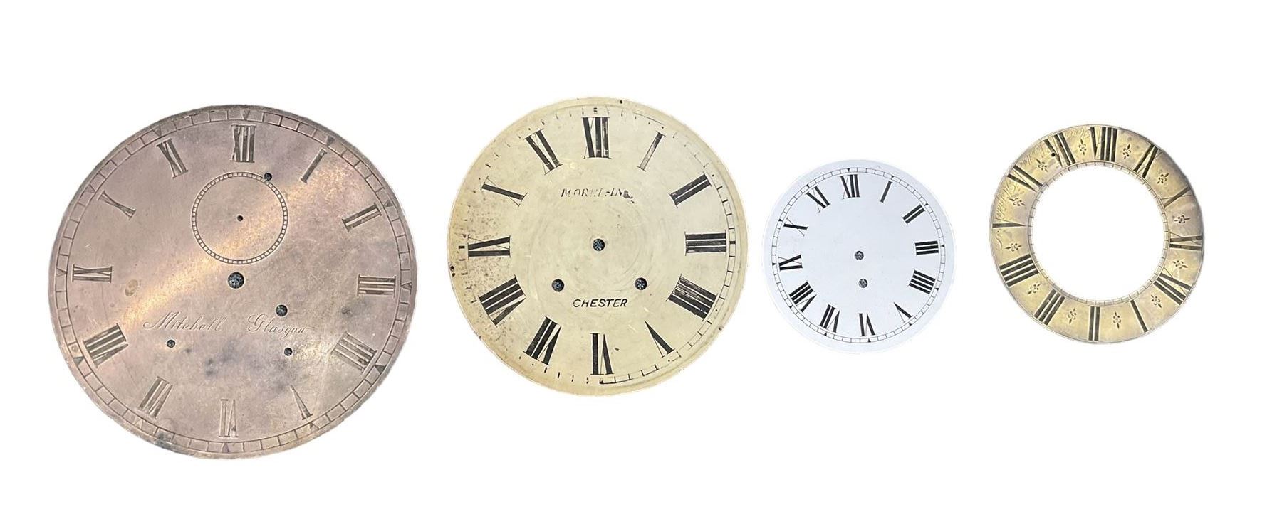 Six clock dials and an engraved brass chapter ring.
Comprising of four 18th century brass longcase dials with two painted wall clock dials and an 18th century engraved single-handed brass chapter ring.