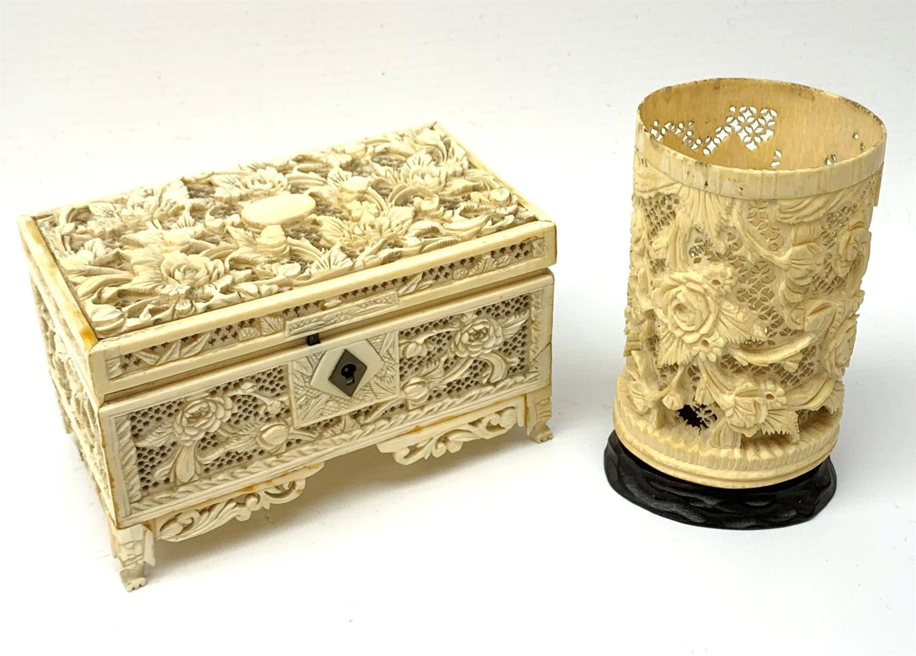 19th century Cantonese carved and pierced ivory small trinket box, L13.5cm and a similar cylindrical vase on hardwood stand H11cm (2)