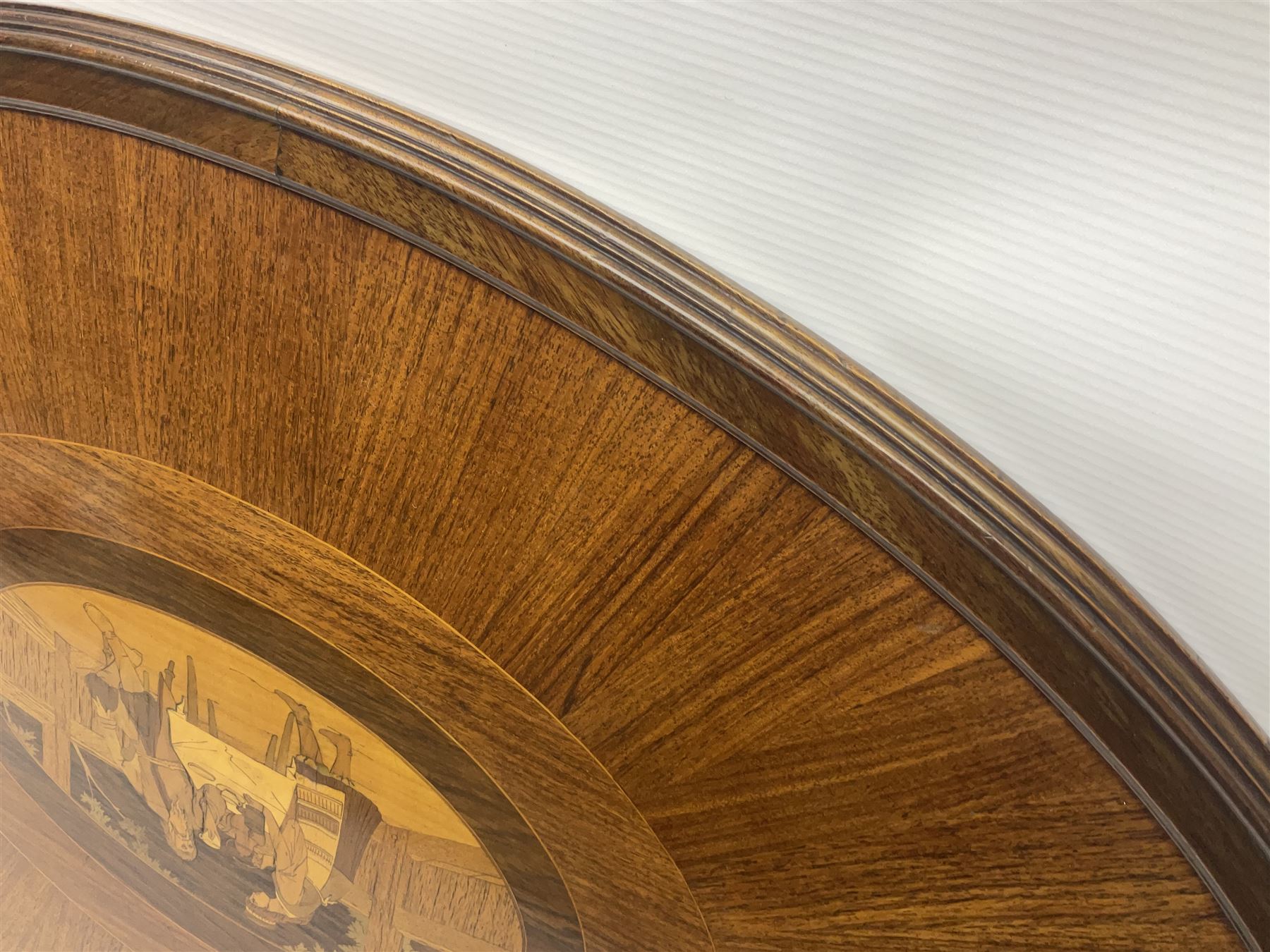 Late 19th/early 20th century mahogany and marquetry inlaid tray, of oval form with twin scrolled handles and moulded border, the central panel inlaid with figures seated at a table drinking tea, L99cm