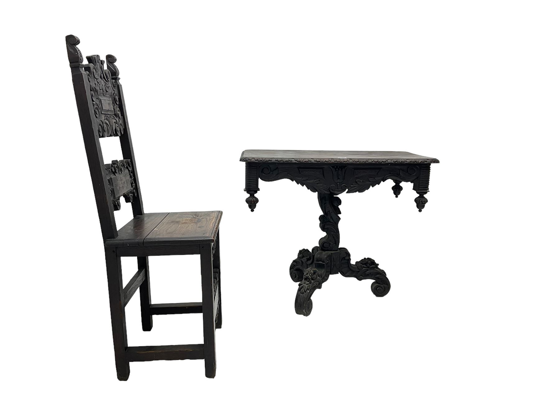 Late 19th century Gothic revival carved oak pedestal table, rectangular top with carved edges, apron carved with trailing foliate and scrolled decoration, heavily detailed column with scrolling decoration and floral carvings, the tripod base with cabriole supports carved with flowerheads (93cm x 53cm x 75cm; Late 19th century carved oak hall chair, panelled back rails with extending scroll decoration (51cm x 40cm x 116cm)
