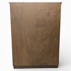 Edwardian oak glazed cabinet, moulded cornice above a panelled front and sides, fitted with lead glazed doors enclosing shelved interior, left side full length cupboard converted to enclose a gun cabinet, on a plain plinth base 