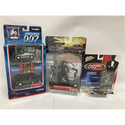 Corgi - The Definitive Bond Collection and The Director's Cut - nine die-cast vehicles from You Only Live Twice, Goldfinger, For Your Eyes Only, Diamonds Are Forever etc; Corgi Classics Moonraker Shuttle and Lotus Esprit; two other Corgi James Bond packs; Carrera Die Another Day Aston Martin V12 Vanquish; nine Johnny Lightning carded James Bond vehicles; Dragon carded Wai Lin figure; and three Fabbri tanks; all boxed/packaged (27)