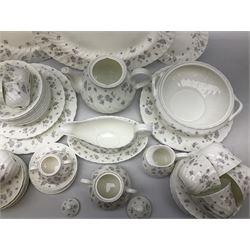 Wedgwood tea and dinner service decorated in the ‘April Flowers’ pattern, to include nine bowls, seven teacups and saucers, three coffee cups and saucers, sauce boat and stand, lidded tureen, covered sucrier and another smaller, oval serving plate, twelve side plates, teapot, four dinner plates, jug and shallow bowl