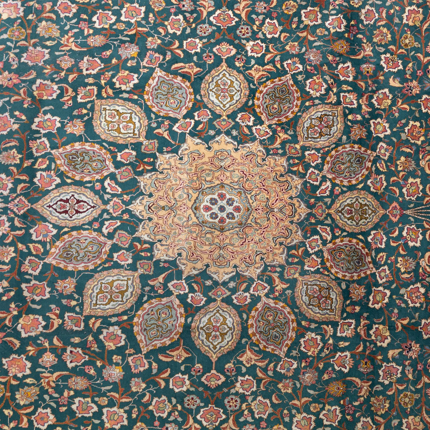 Persian Tabriz type carpet, the teal ground decorated with central medallion, radiating palmettes and dense floral scrollwork, within multiple floral borders