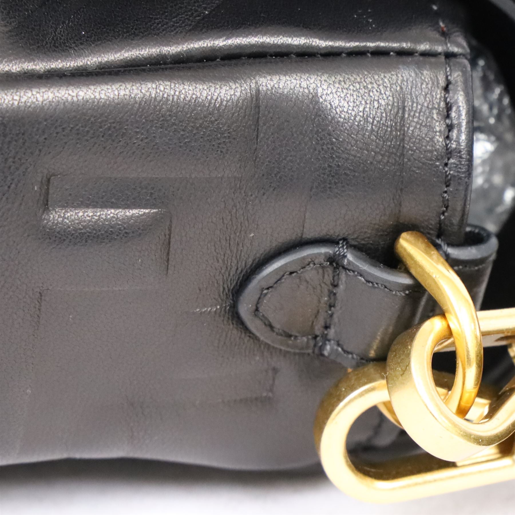 Fendi Baguette shoulder bag, black nappa leather with embossed FF monogram and quilted panels, the front flap secured by a gold-tone FF logo magnetic clasp engraved Fendi Made in Italy, with detachable leather shoulder strap and gold-tone hardware, interior leather tab stamped 'Baguette Fendi Made in Italy', together with original Fendi dust bag and box, W27cm D7cm H15cm
