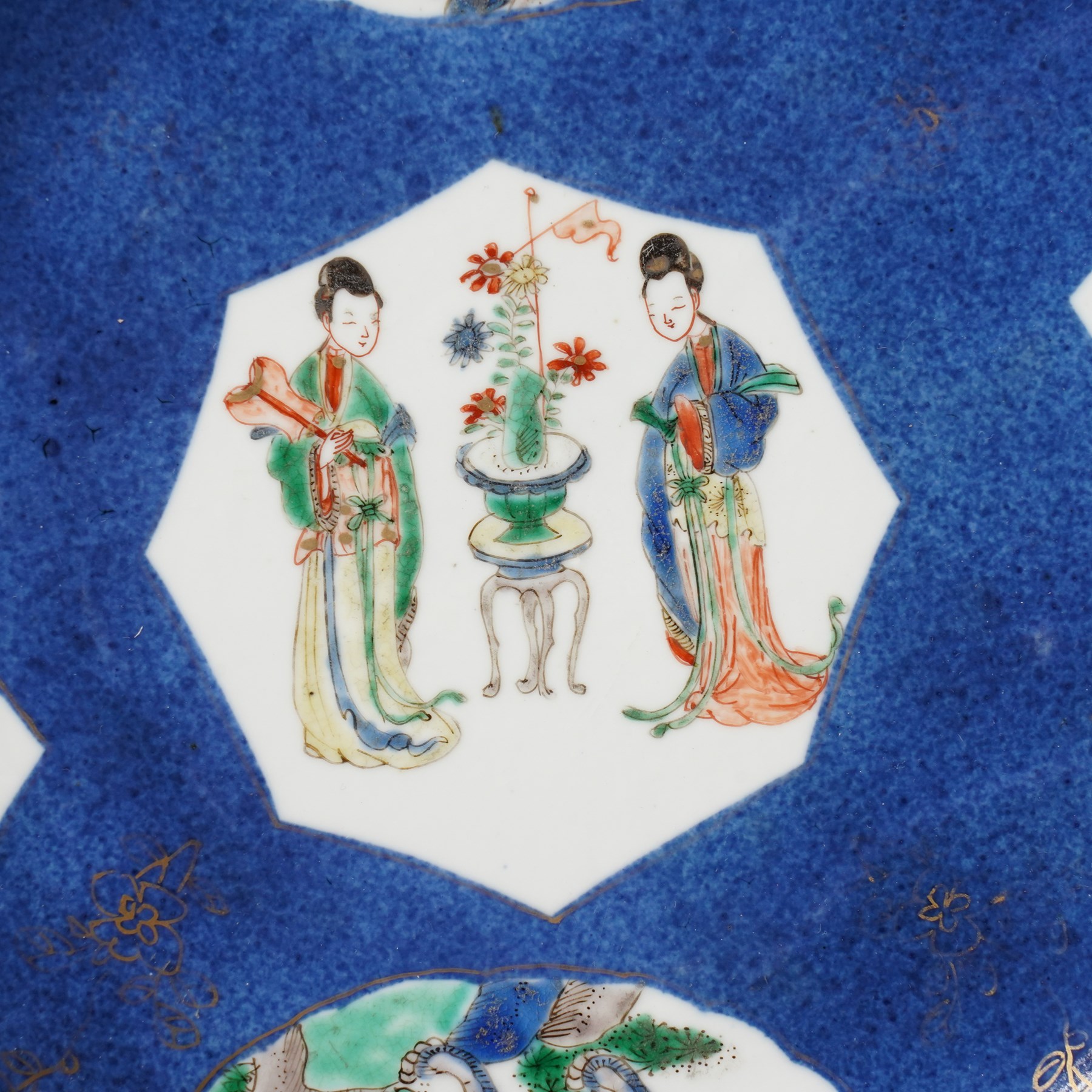 Chinese powder blue ground famille verte charger, possibly Kangxi, decorated with a central cartouche enclosing two female figures, with smaller shaped panels enclosing lions and foliage, square seal mark in blue to base, D28cm