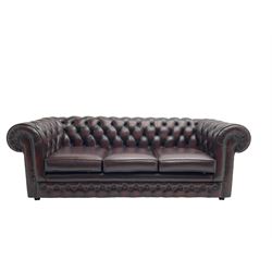 Thomas Lloyd - three seat Chesterfield sofa, upholstered in buttoned oxblood leather, on castors 