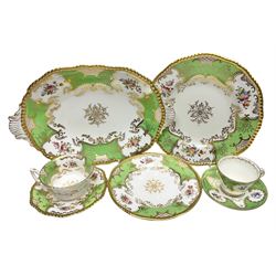 Coalport green batwing pattern tea wares, decorated with finely enamelled floral sprays within gilt reserves, comprising teacup trio, twin handled cake plate and side plate, pattern no Y2665, together with a Coalport for Harrods cup and saucer similarly decorated, the saucer with stamped mark beneath 'Manufactured for Harrods Ltd, Brompton Rd London', all with green Coalport AD 1750 marks beneath, largest W31cm (7)