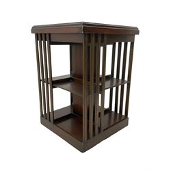 Edwardian revival inlaid mahogany revolving bookcase, square form with moulded top inlaid with central fan motif, two-tiers with moulded upright rails, on castors 