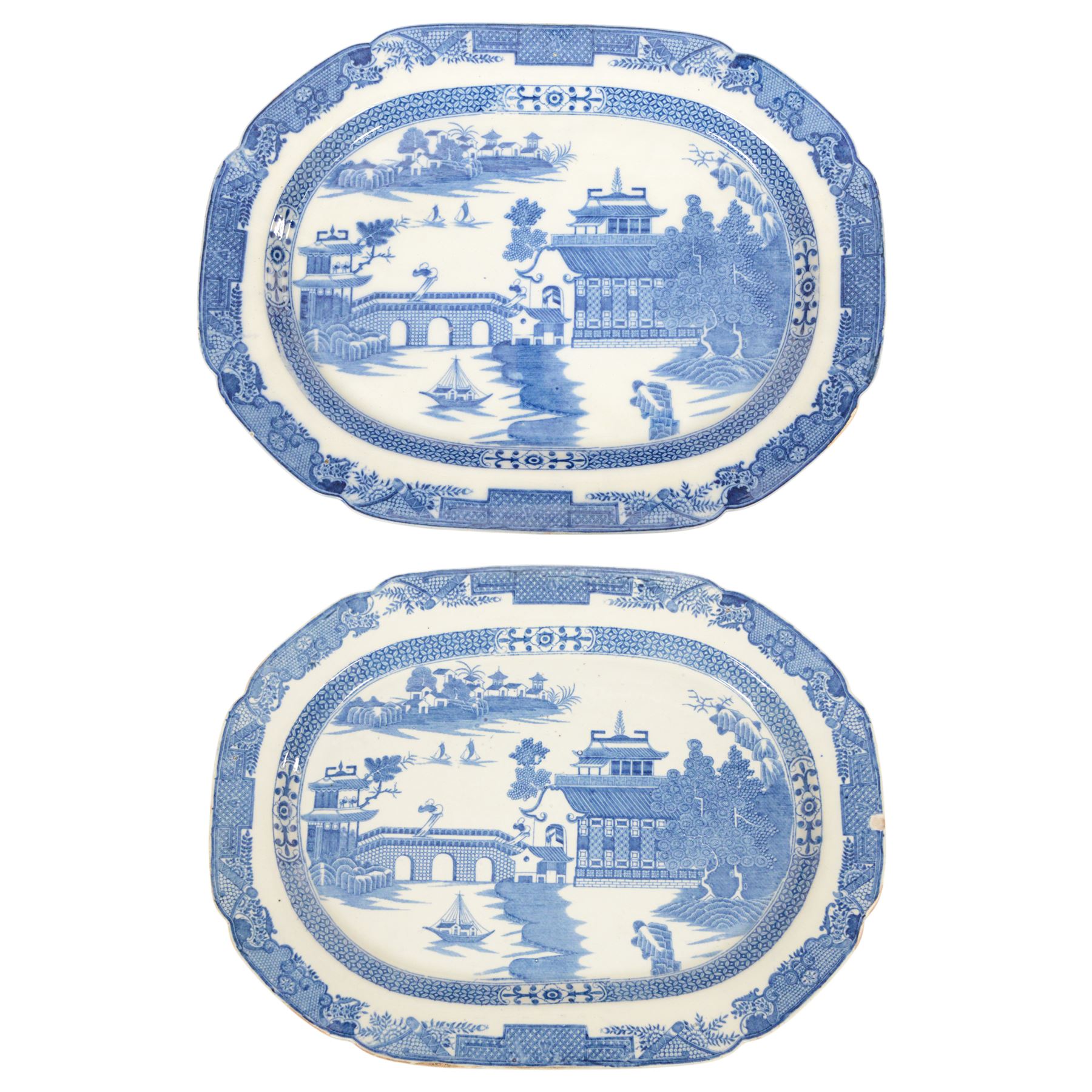 Pair of large 19th century blue and white platters, decorated in the Long Bridge pattern with pagodas, boats and figures, within a decorative border with scrolls, D39.5cm W52cm
