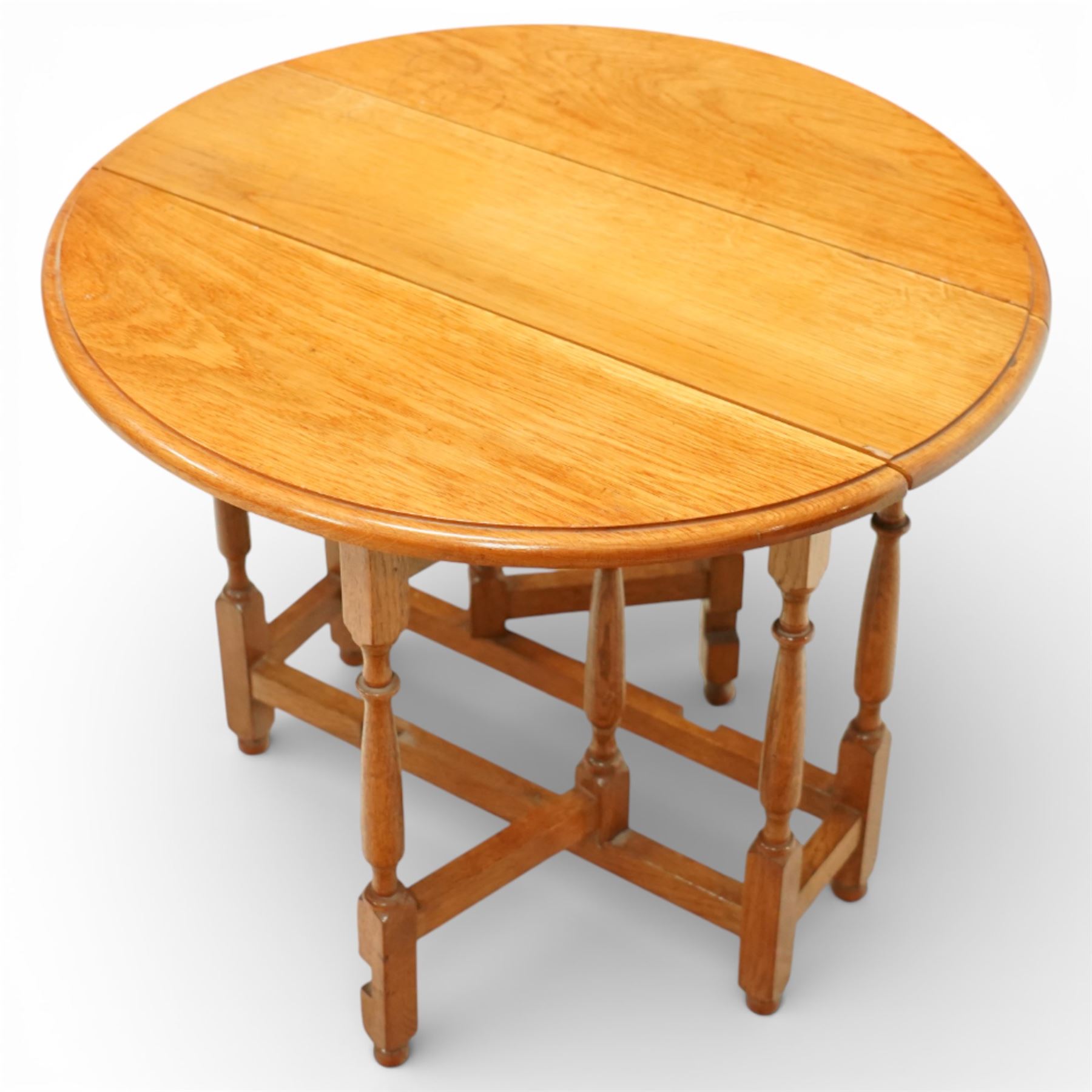Late 20th century small oak gate leg side table, with circular drop-leaf top formed of three planks, raised on turned supports with gate legs and rectangular stretchers