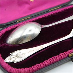 1920s Danish silver spoon and fork set by Georg Jensen, stamped 925S Georg Jensen, with import marks for London 1926, contained within fitted tooled leather retailers case, together with two Georg Jensen silver-gilt year spoons, comprising 1975 example with enamel woodruff flower decoration, with personal inscription verso and a 1973 example with enamel marigold decoration, both boxed