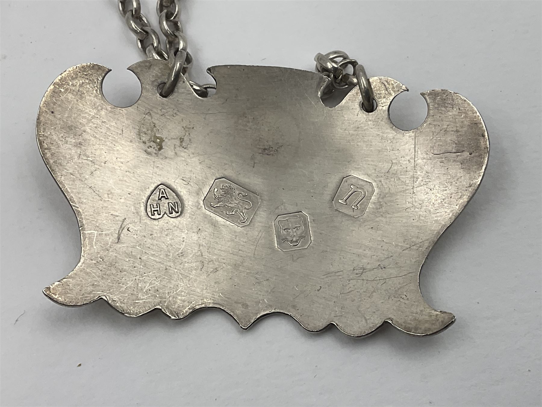 Five modern silver decanter labels, to include two sherry examples, embossed with scrolls and fruits, hallmarked W I Broadway & Co, Birmingham 1991 & 1997, a similar claret example, hallmarked S J Rose & Son, Birmingham 1973, and two plain shaped port and burgundy examples, hallmarked C Robathan & Son, Birmingham 1997 and A Haviland-Nye, London 1968