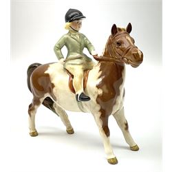 Beswick girl on skewbald pony model no 1499, with printed mark beneath. 