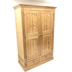 Pine wardrobe, projecting cornice, two doors above two drawers, plinth base