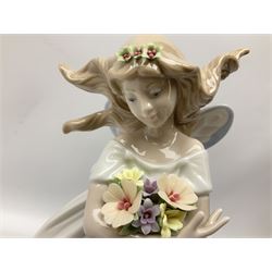 Lladro figure, Mystical Garden, no 6686, modelled as a fairy with flowers in arms, upon a naturalistically modelled base detailed with encrusted flowers, H31cm