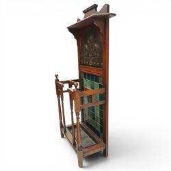 Shapland & Petter of Barnstaple - Arts & Crafts mahogany tile-backed umbrella or stick hall-stand, model no.114, the shaped back with single shelf over an Art Nouveau embossed patinated copper panel and turquoise tiled back, with turned supports and dividers over inset metal drip tray

Notes: A comparable Shapland & Petter stick stand of this model is recorded in Daryl Bennett, Shapland & Petter Ltd of Barnstaple, Museum of Barnstaple and North Devon, p.84, cat. no.5.37, and the model is also listed in Bennett, Liberty’s Furniture 1875-1915, p.298, cat. no.8.6. Examples of this model are known to have been retailed by Liberty & Co.