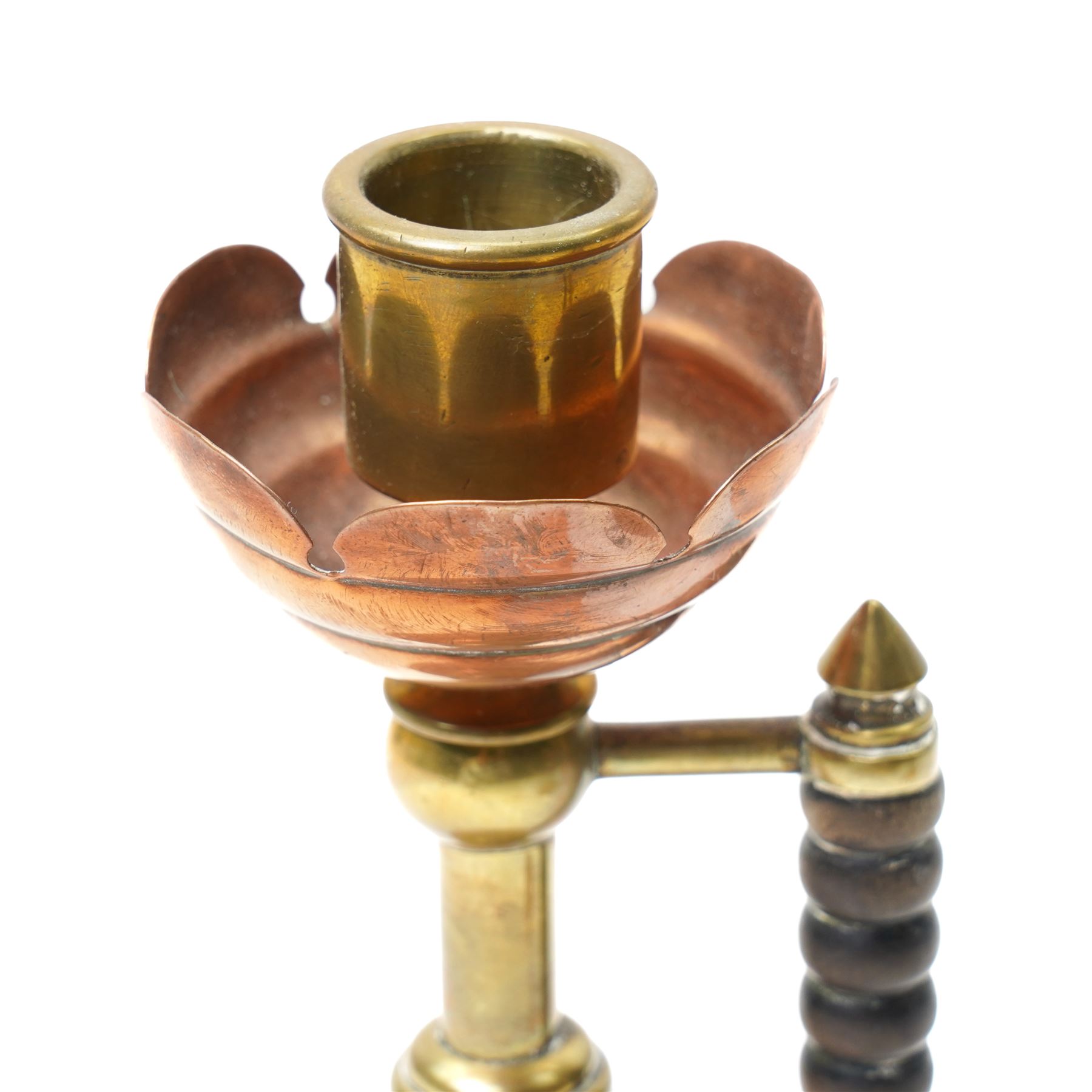 Pair of Arts and Crafts brass and copper candlesticks after a design by Dr Christopher Dresser with bobbin turned hardwood handles on domed weighted bases Rd No.5379 H19cm