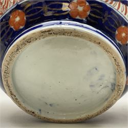 Pair of large 19th century Japanese Imari porcelain bottle vases, painted with shaped reserves of peonies, chrysanthemums and prunus blossom, each H46cm