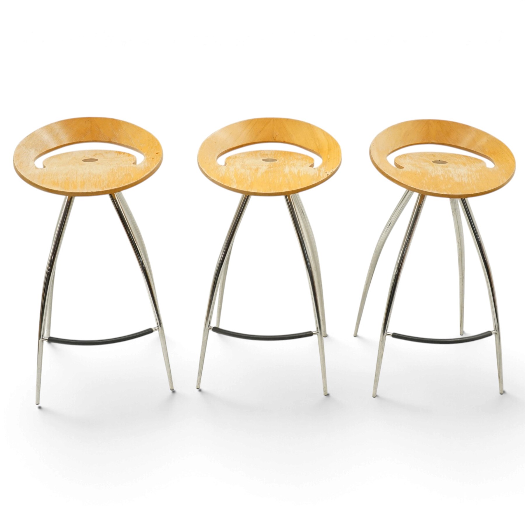 Lyra - set of three bar stools, dished plywood seats with wraparound low backs and crescent apertures, on outward swept chrome supports with contrasting black footrests