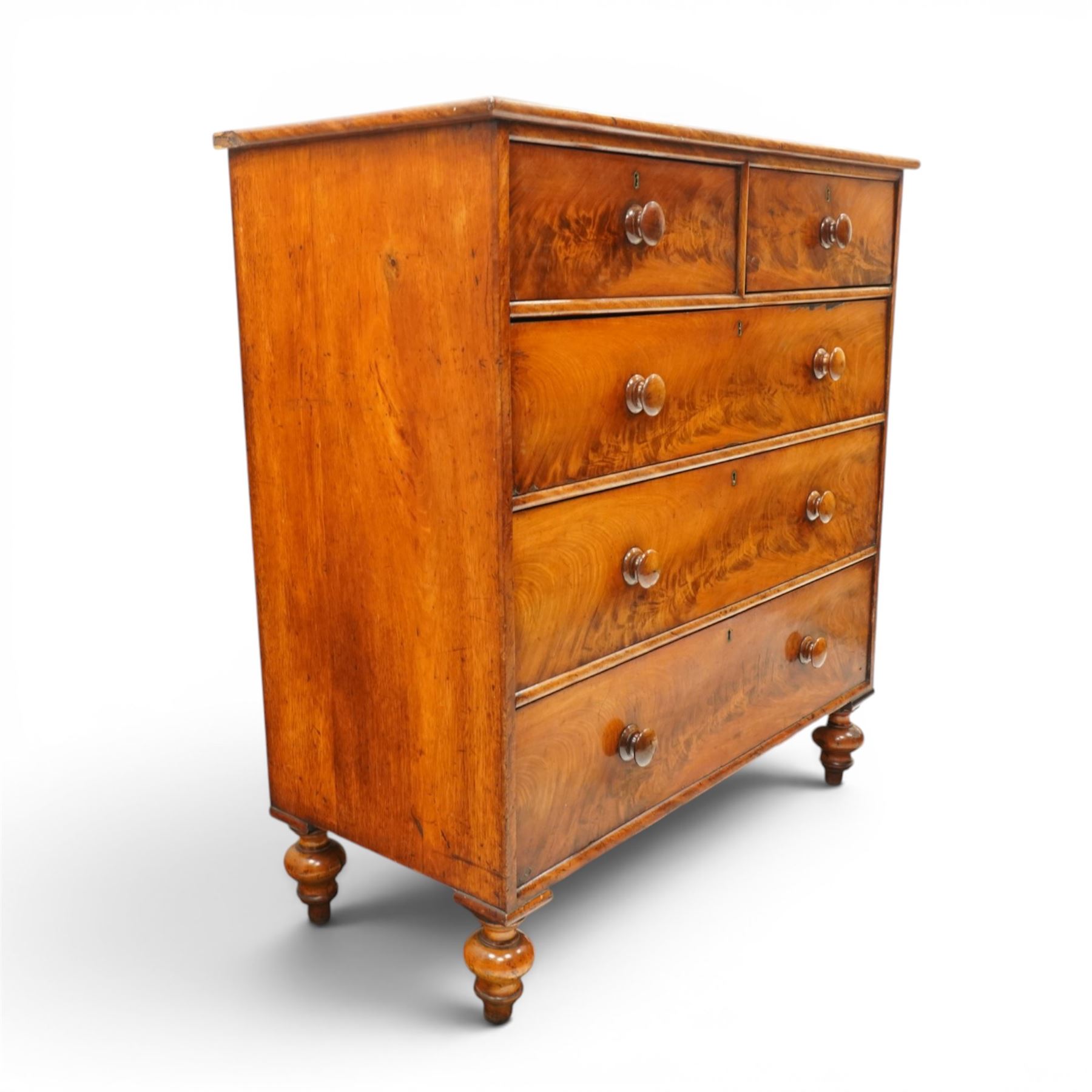 Mid-Victorian figured mahogany chest of drawers, circa 1860, rectangular moulded top over two short and three long drawers with figured veneers, on turned supports