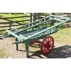 Costermonger’s Cart

A painted costermonger’s cart with green slatted timber body, red painted wooden spoked wheels and red leaf spring suspension. The cart is fitted with raised side rails, turned supports and short projecting handles. Painted lettering is visible along the side rails, together with the number “661” to the frame and wheel rim.
Finished in traditional colours, the cart offers excellent decorative appeal and would be suitable for display, garden or country house settings.

Dimensions:
Overall length: 240 cm
Body length: 215 cm
Width: 94 cm
Height: 86 cm
Wheel diameter: 64 cm

Features:
Timber construction
Open slatted carrying platform
Shaped side rails
Leaf spring suspension
Wooden spoked wheels
Iron tyres
Iron fittings throughout
Carved ownership and maker inscriptions
Traditional painted finish

