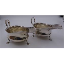 Pair of early 20th century silver sauce boats, each of typical form with scroll handles and shaped rims, upon three stylised pad feet, hallmarked Martin Hall & Co Ltd, Sheffield 1912, including handle H8cm, approximate total weight 8 ozt (248.9 grams)