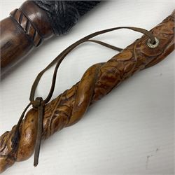 19th century wooden walking stick, the handle carved as a snake within a clenched fist, the cane carved with foliate and cross hatched decoration, with a metal spike to base, together with a turned wooden walking stick, with lacquered rope nautical knot handle, tallest L96.5cm