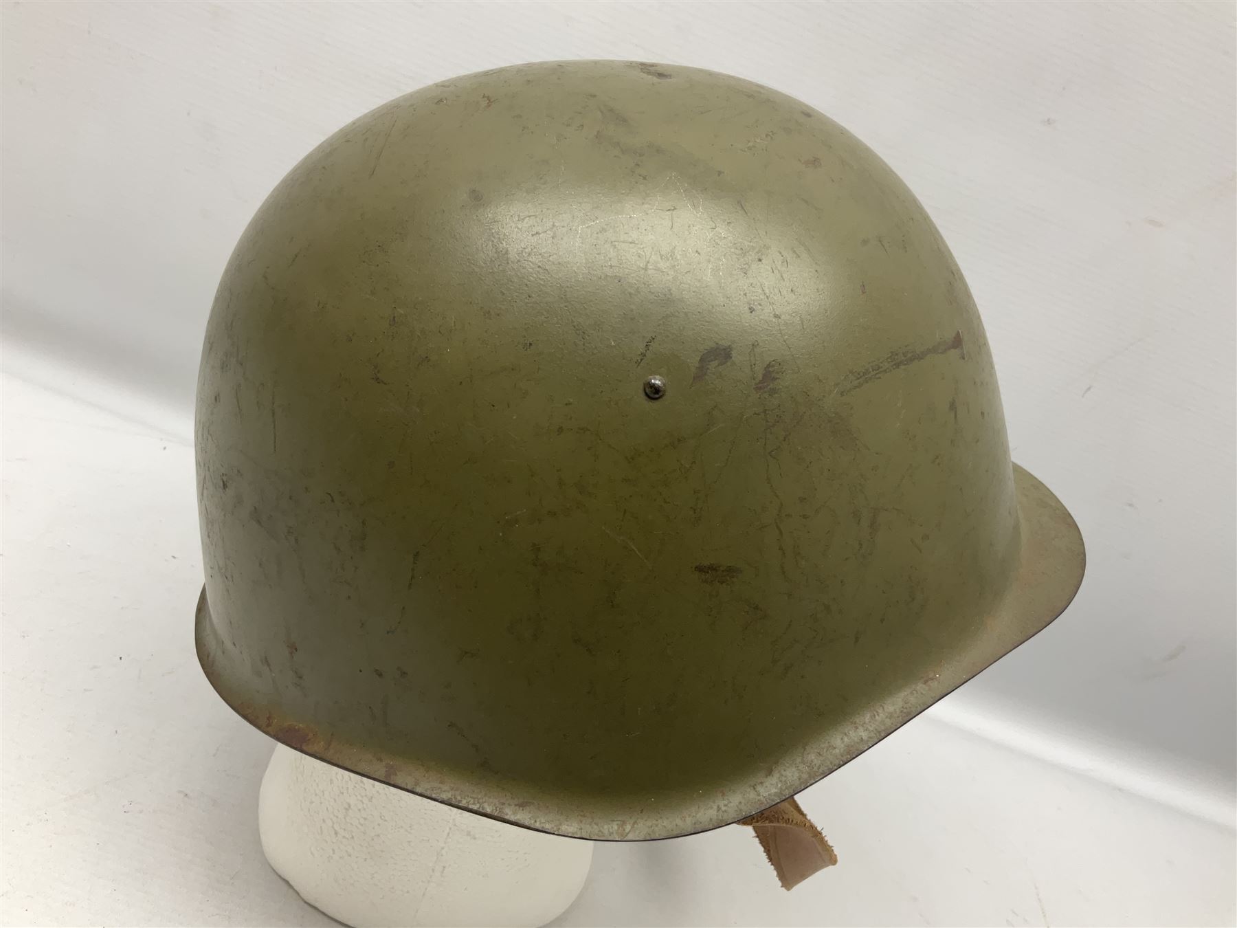 Two 1960s East Block Soviet style helmets - Czechoslovakian and Russian; both with liners (2)