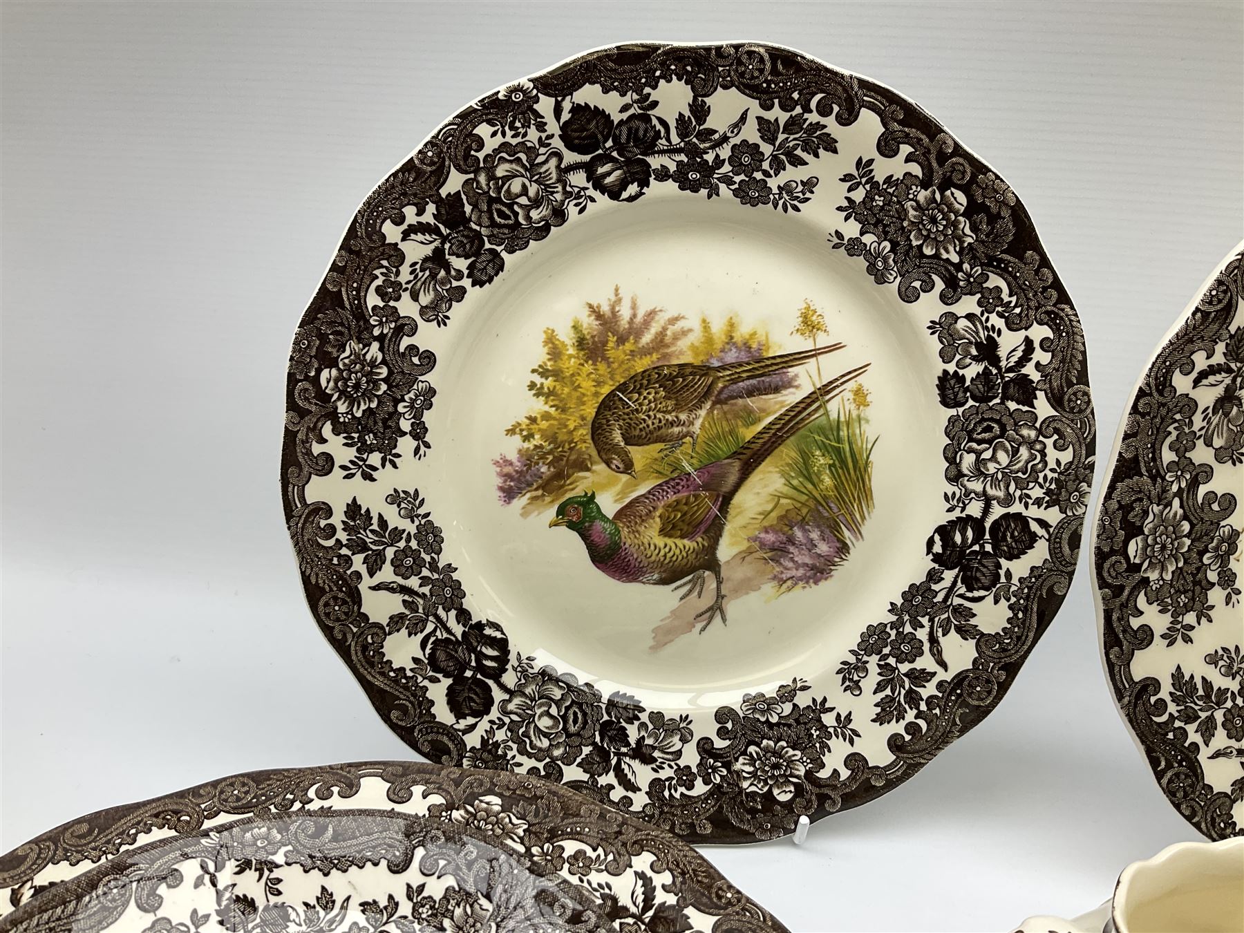 Royal Worcester Palissy Game Series pattern dinner wares, comprising seven dinner plates, six side plates, twelve bowls, sauce boat and stand, six tea cups, eight saucers, further larger saucer, milk jug, and open sucrier. 