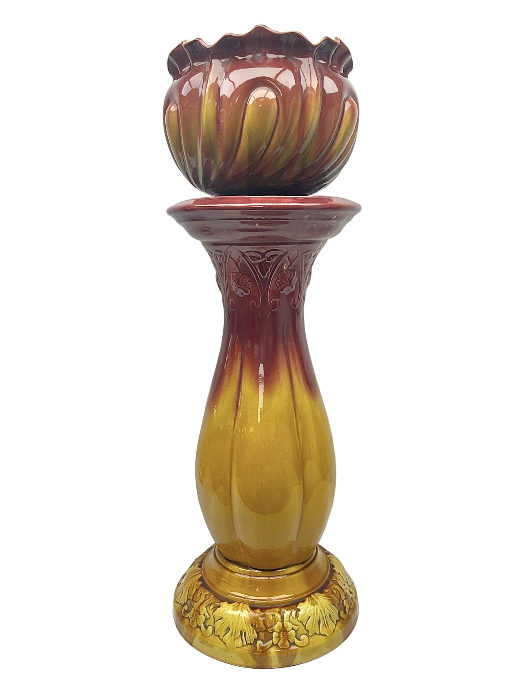 Bretby Jardiniere and stand, with foliate and foliage decoration with a red and yellow ground, impressed mark beneath H94cm