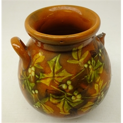  Linthorpe two handled vase, painted with berries and foliage on mustard ground, probably by Christopher Dresser, impressed back stamp and a.y, H12cm   
