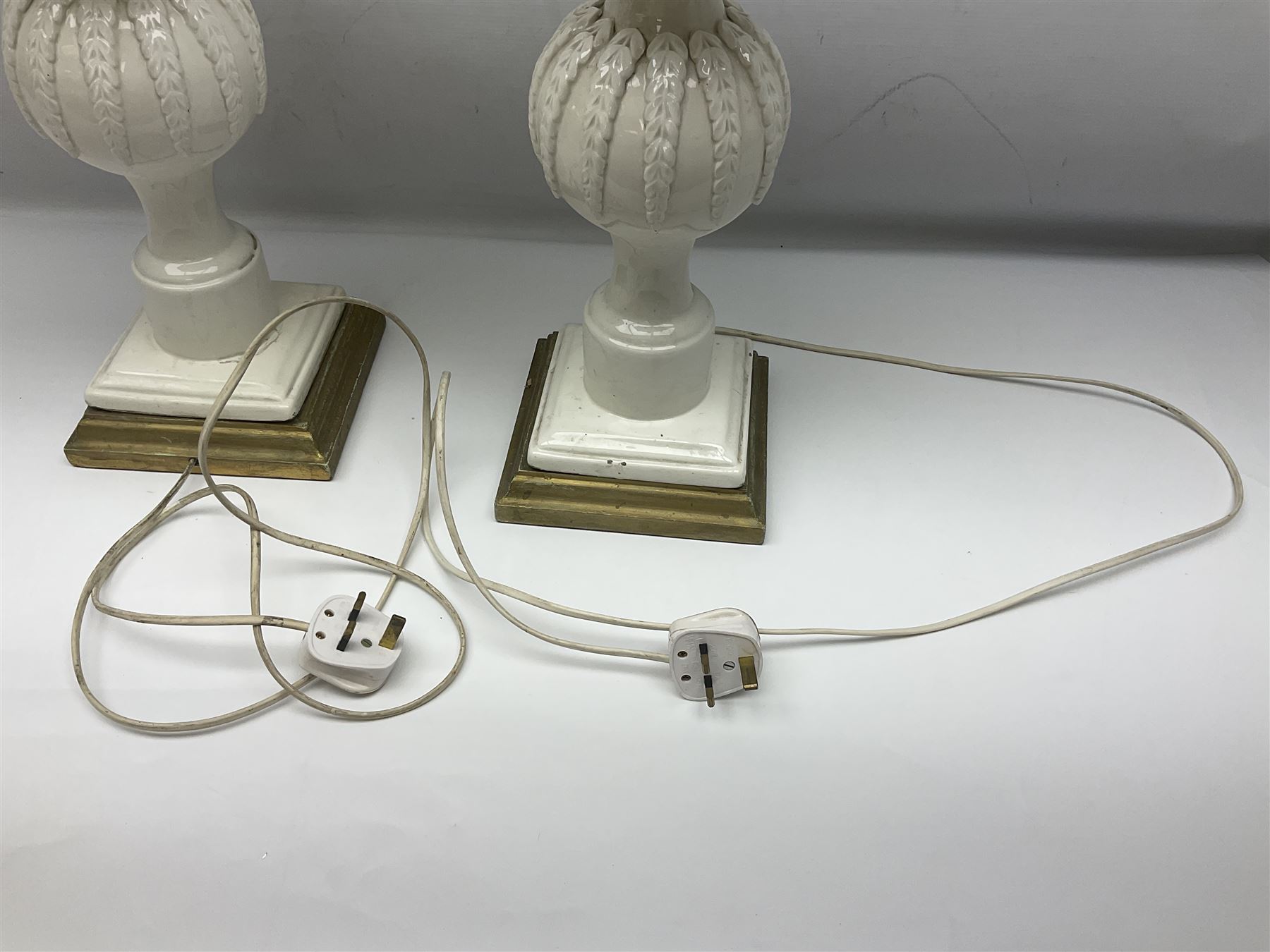 Pair of Casa Pupo white-glazed table lamps, modelled as a fruit upon a column of baluster form with foliate decoration, on a giltwood base, H62cm