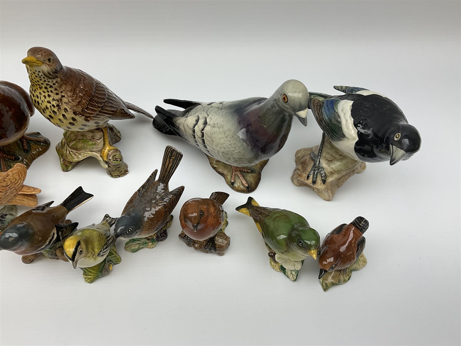 Collection of Beswick figures, to include wren model no 993, Greenfinch model no 2105, Robin model no 980, whitethroat model no 2106, stonechat model no 2274, chaffinch no 991, magpie model no 2305, etc.