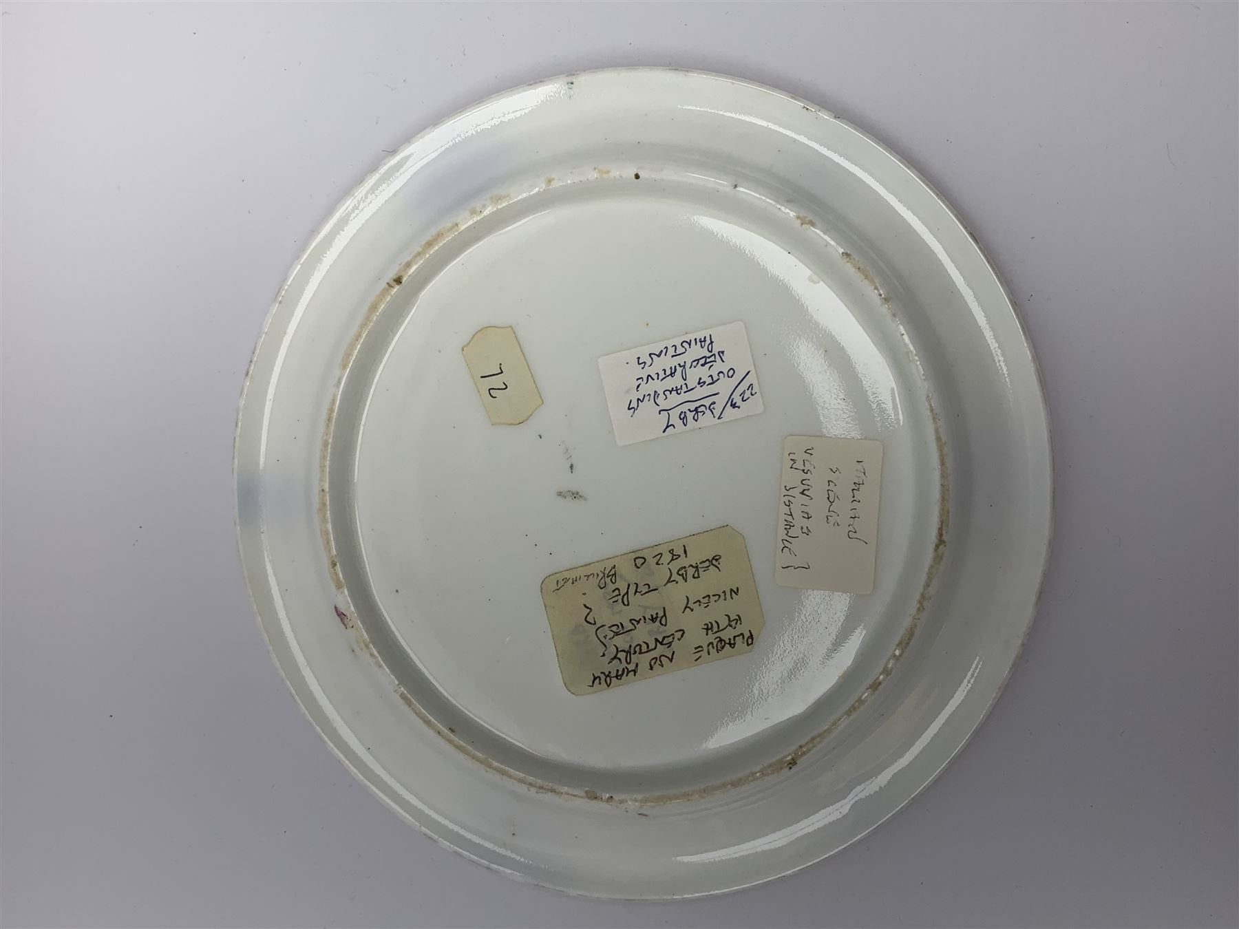 19th century porcelain stand, of circular form, in the Derby style, hand painted with a ruinous column and roses against a landscape background, within a gilt border, D7cm