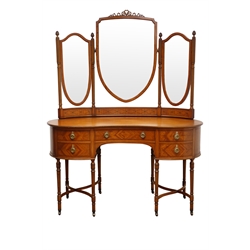  Edwardian Sheraton Revival satinwood kidney shaped dressing table, with three mirrors on fluted supports with pineapple finials, the one long and four short drawers with brass ring handles on fluted tapering supports with brass sockets and castors joined by curved stretchers, H160cm, W142cm, D70cm  