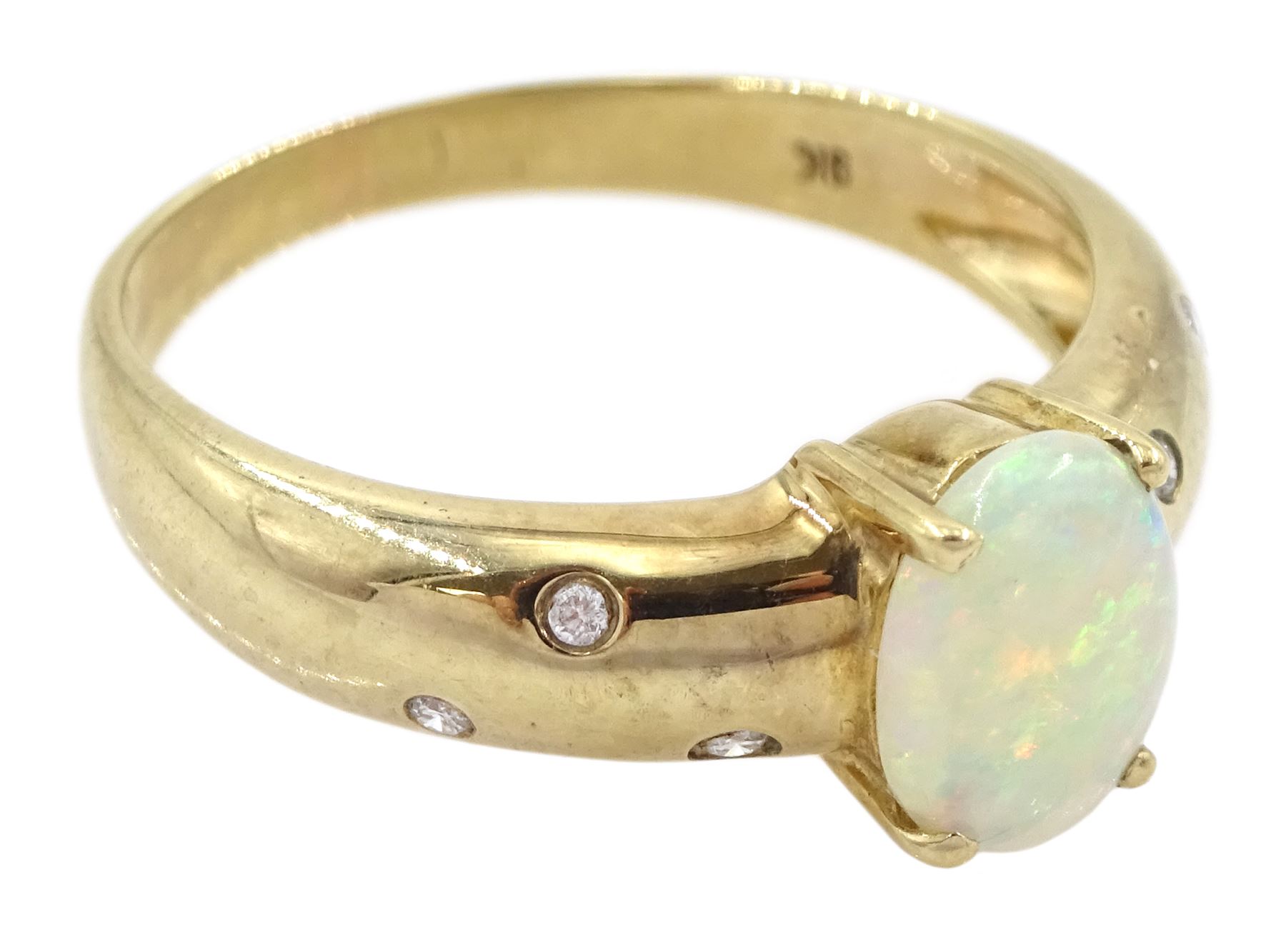 9ct gold opal ring, either side with three rubover set, round brilliant cut diamonds, Sheffield 2004