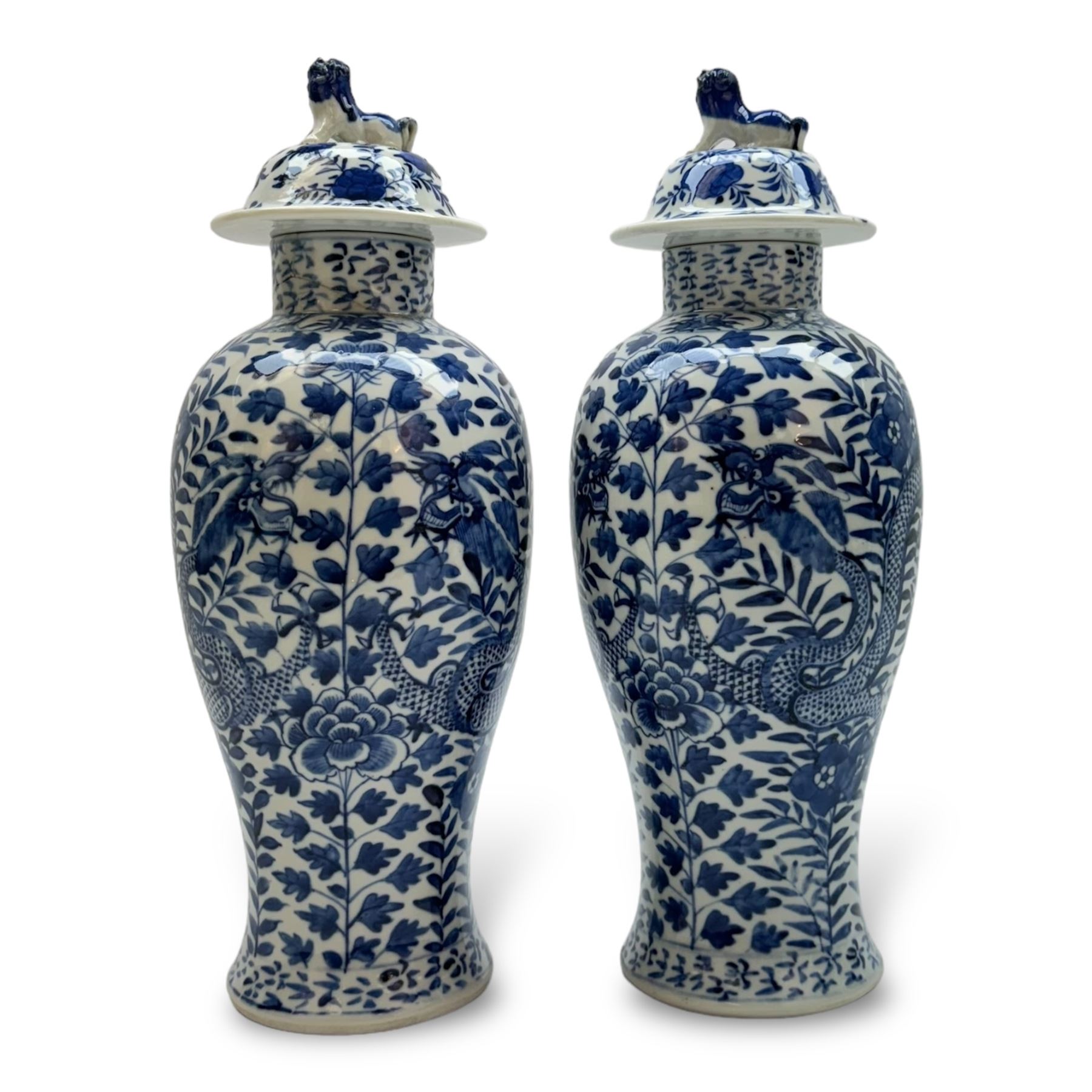 Pair of Chinese vases and covers, of baluster form the blue and white design depicting dragons in foliage, with character marks beneath, H38cm