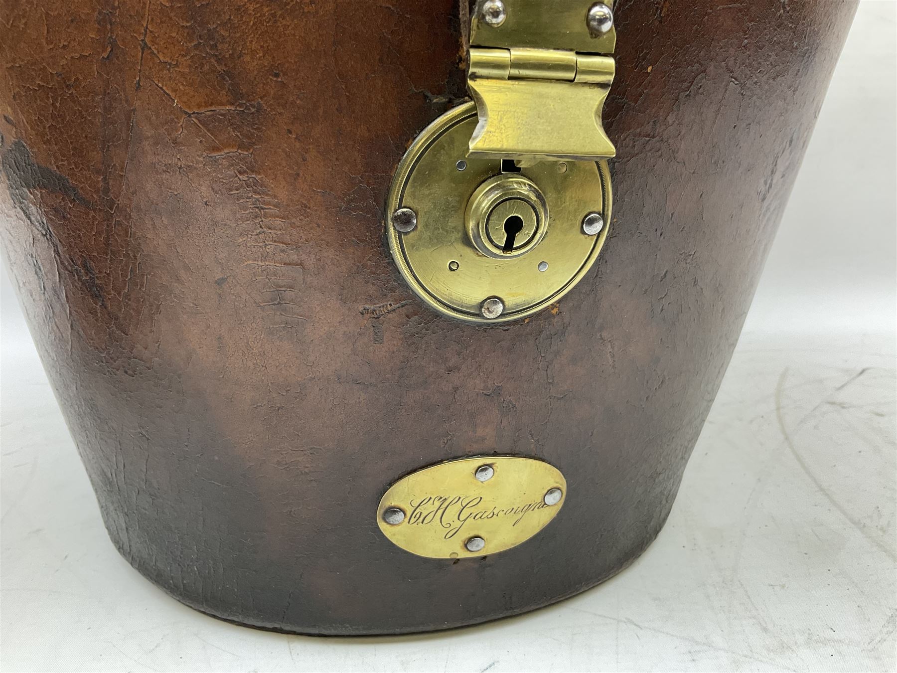 Early 20th century black silk top hat by Woodrow of Manchester and London, with manufacturer's stamp to the silk lined interior, housed in fitted tan leather hat box with removable internal compartments with straps, brass escutcheon and engraved plaque, hat internal measurements approx 20cm x 15cm
