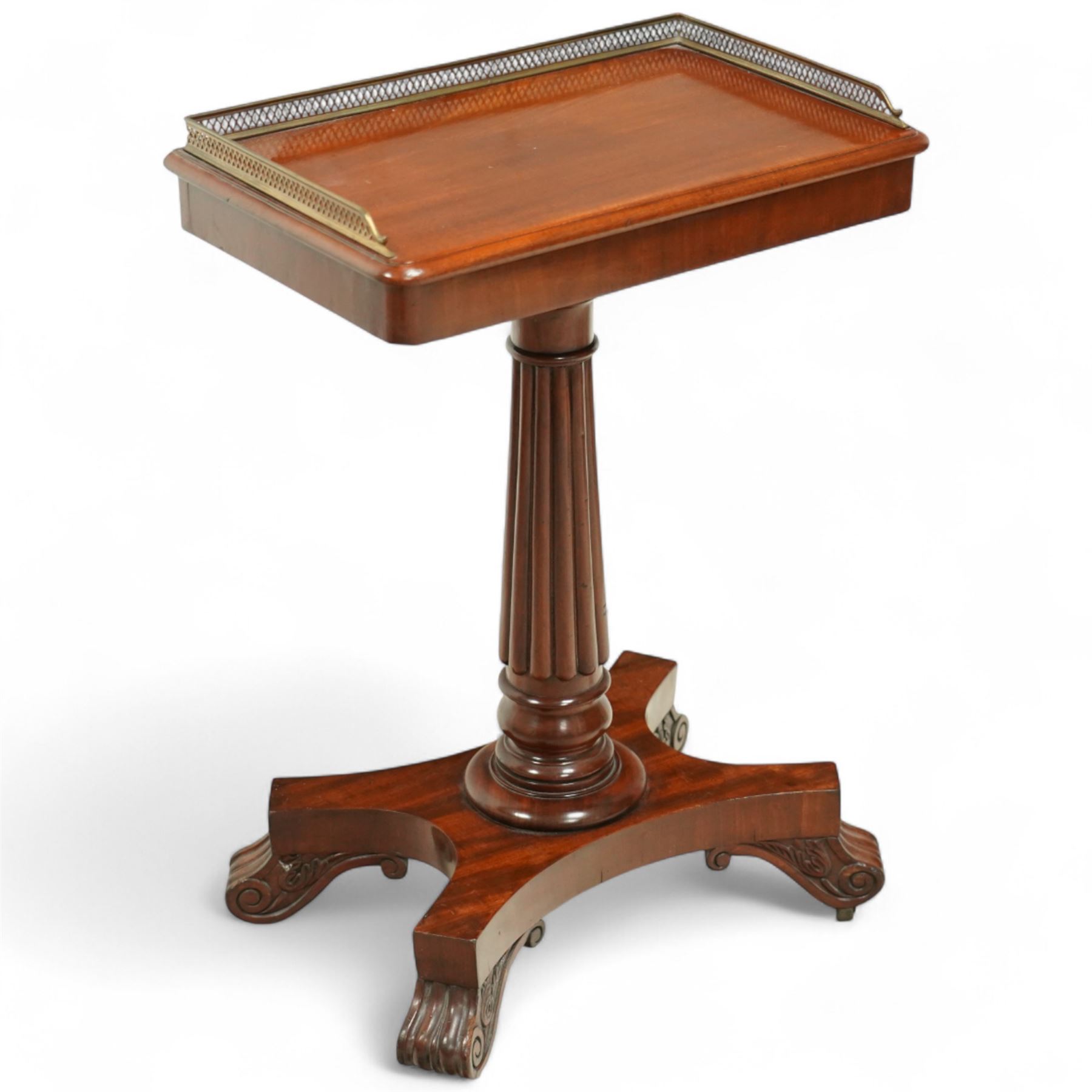 Late Regency mahogany side table in the manner of Gillows, the rectangular top with pierced brass gallery, raised on a reeded column and quatreform base with scroll carved feet with castors 