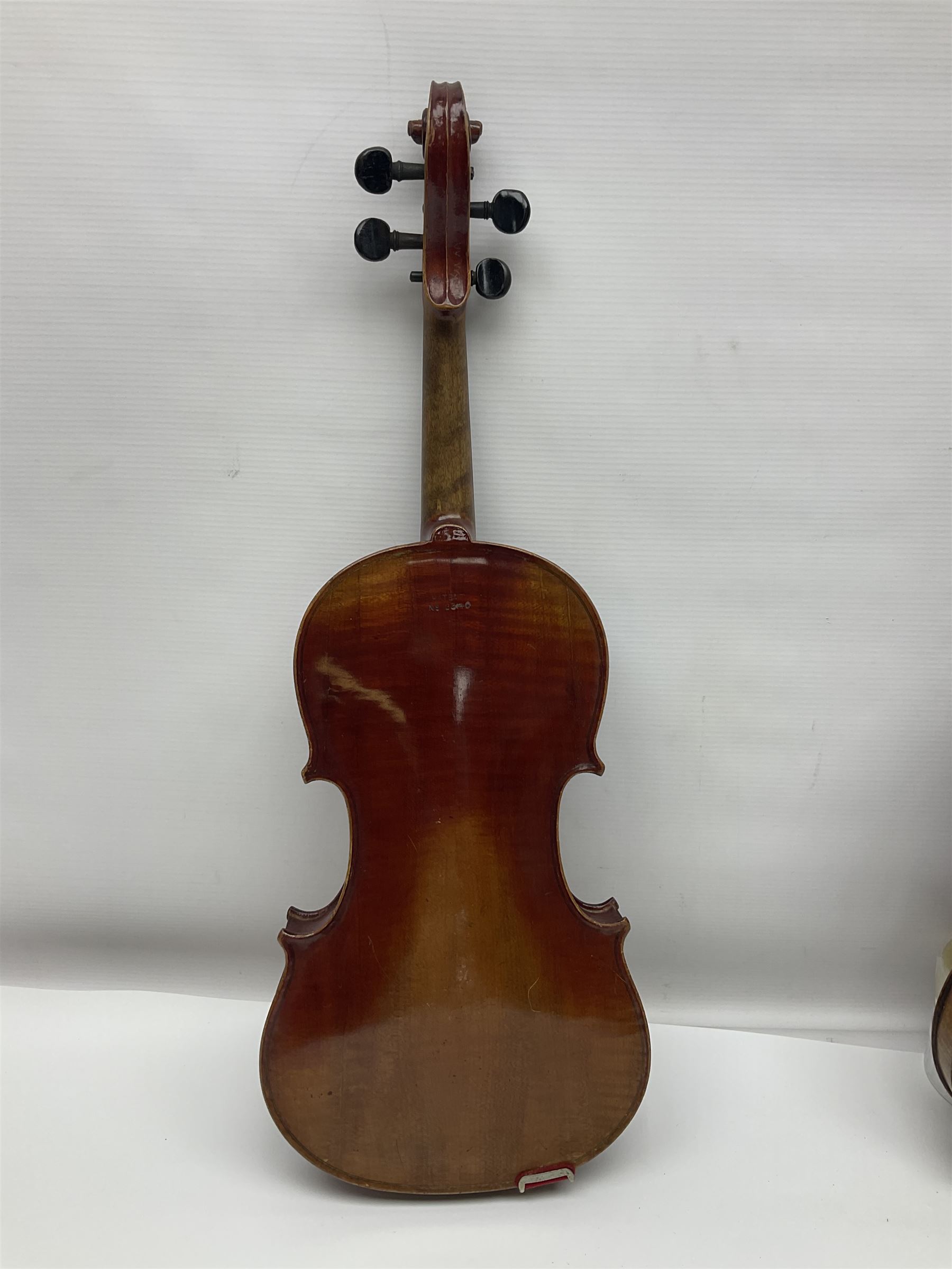 Late 19th century French three-quarter size 'Conservatory' violin with 34cm two-piece maple back and ribs and spruce top, the peg box inscribed 'Conservatory Violin Straduari', bears label 'Antonius Stradiuarius Cremonensis Faciebat Anno 1721' L55.5cm overall; in ebonised wooden 'coffin' case; and Saxony violin c1900 with 36cm two-piece maple back and ribs and spruce top; bears label 'Antonius Stradivarius Cremonensis Faciebat Anno 17**' L59cm overall; in carrying case (2)