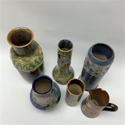 A group of Royal Doulton vases of various form and decoration, to include a vase of cylindrical form with relief moulded flower head decoration upon a mottled blue ground, H27cm, a vase of baluster form with tubelined decoration of roses, H29.5cm, etc. 